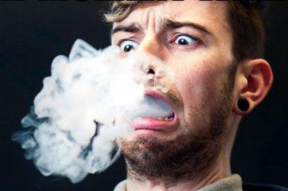 guy inhaling vapor and making a face because of burnt vape taste