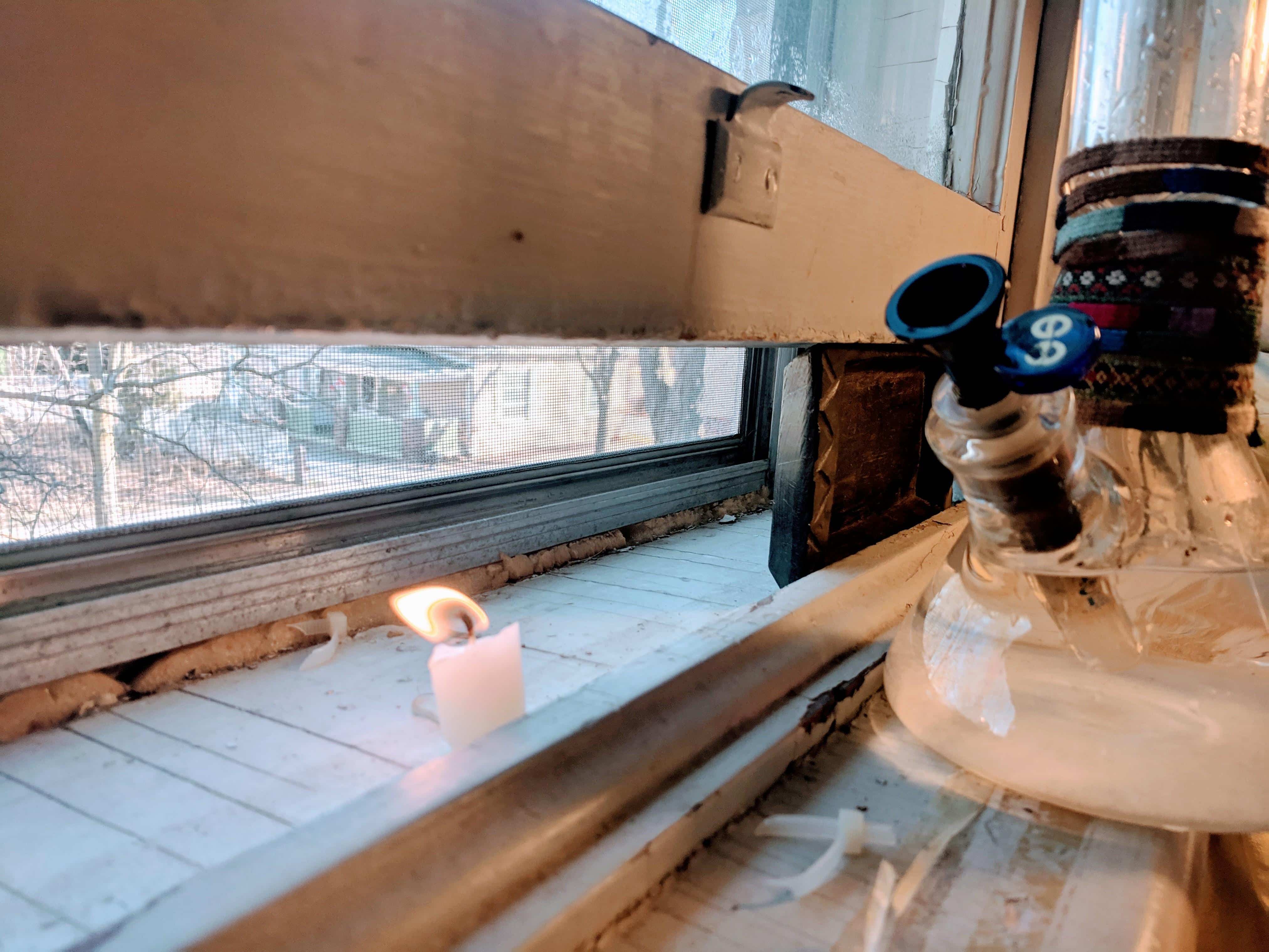 image of a weed bong next to an open window