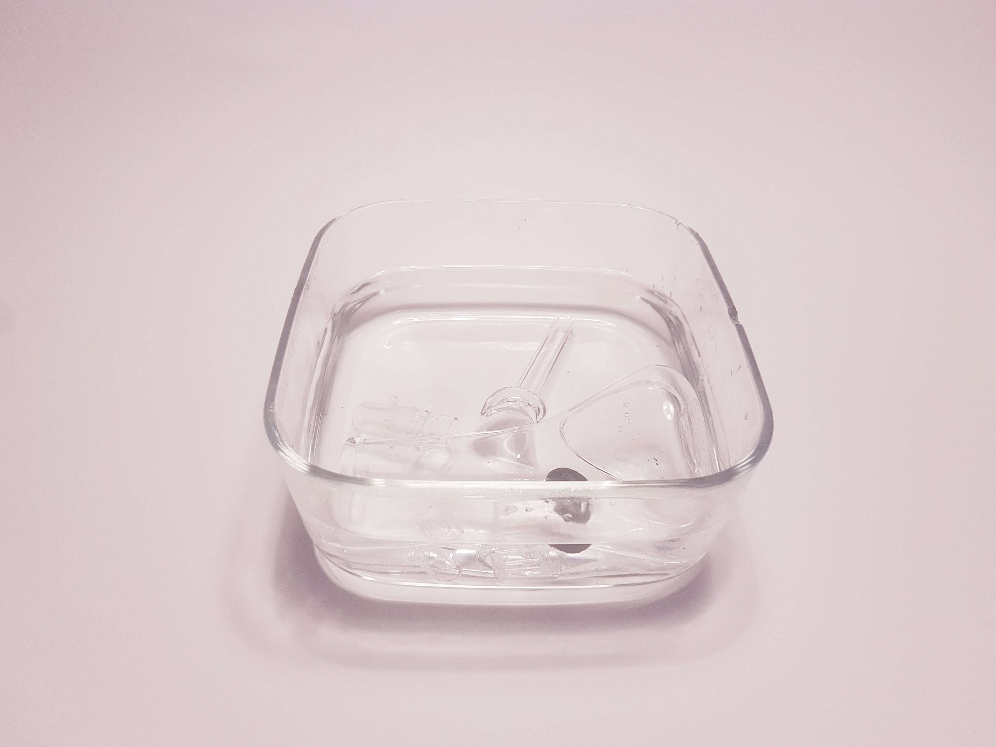 Glassware rinsed in clean water against a white background.