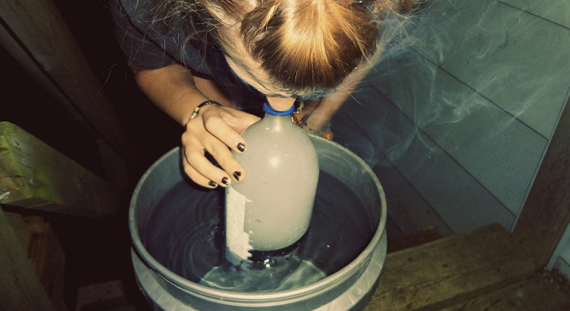 picture of a g-bong and a girl hitting it from a bucket of water