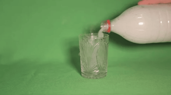 image of a smoke pouring out of a bottle into a glass